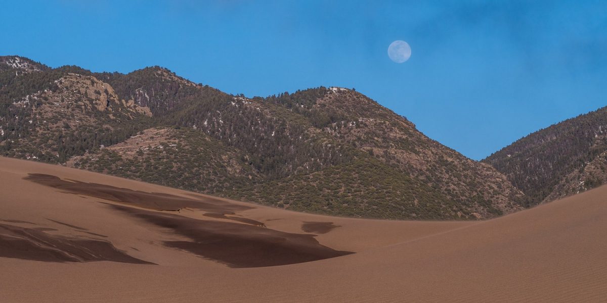 great sand dunes with moon
