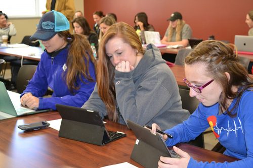 Nursing students studying with iPads