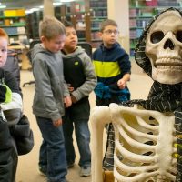 elementary students view a day of the dead altar