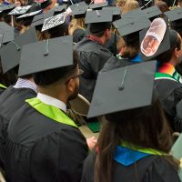 backs of graduates showing caps