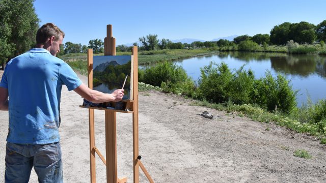 Student painting a landscape near the Rio Grande