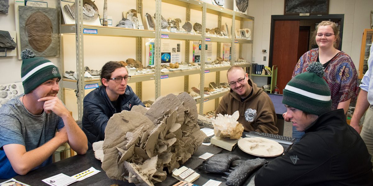 Five students working in the Ryan Geology Museum.