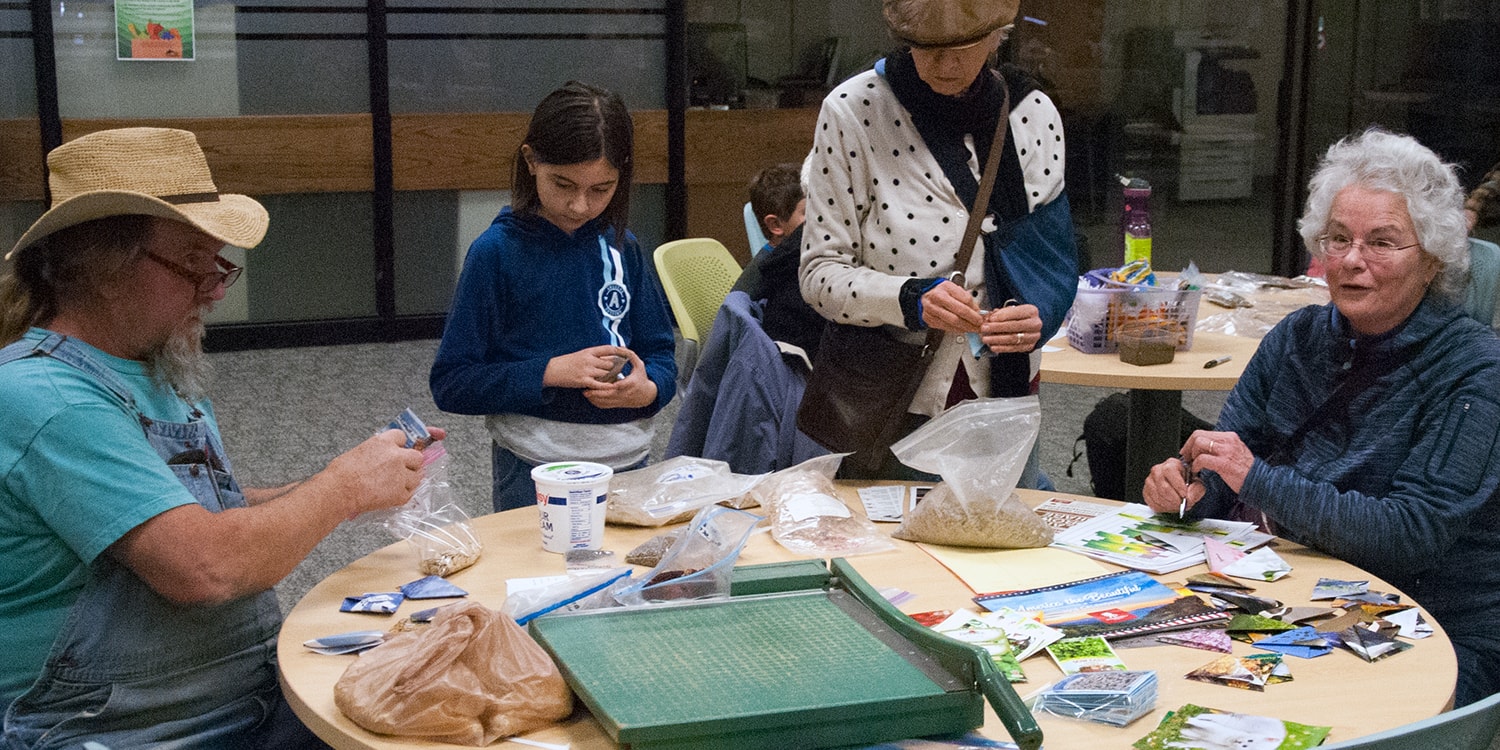 participants of 2018 seed exchange choose seeds from table