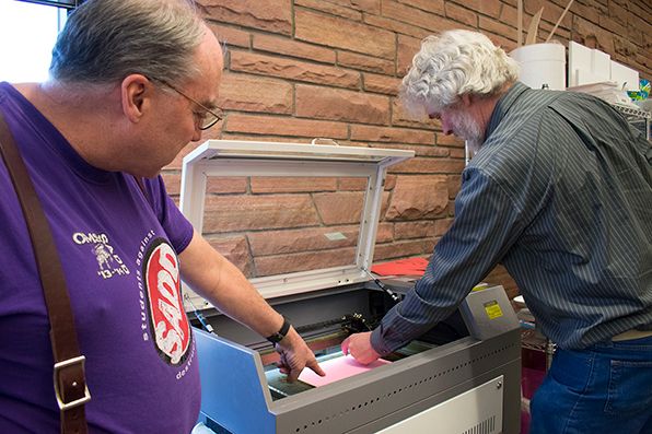 Chris Dahle and George Sellman demonstrate laser cutter
