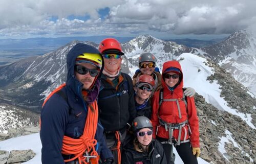 Outdoor Education and Stewardship students standing on a summit during a mountaineering course