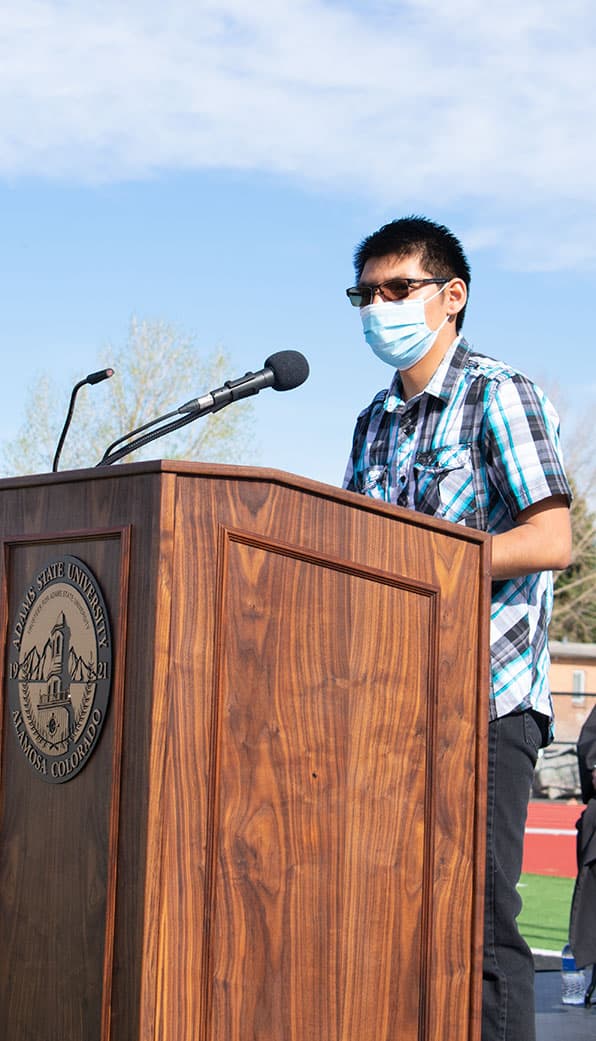 Lathen Tsalate reads LAS at commencement