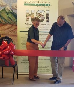 Adams State President Cheryl D. Lovell and Eric Carpio cut ribbon