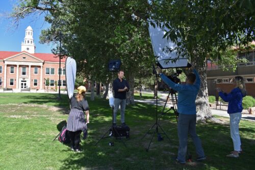A TV crew records on the lawn of Adams State's Richardson Hall