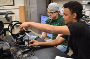 two students working on a project in physics lab