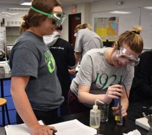 two students doing a chemistry experiment