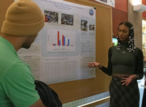 student presenting a research poster