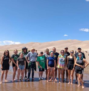 students, faculty and Adams State President at the Sand Dunes