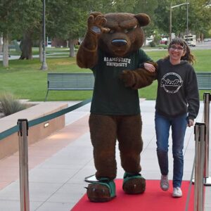 Boomer the Adams State mascot with person