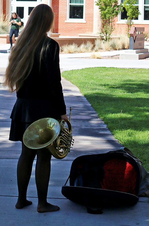 music student standing with musical instrument