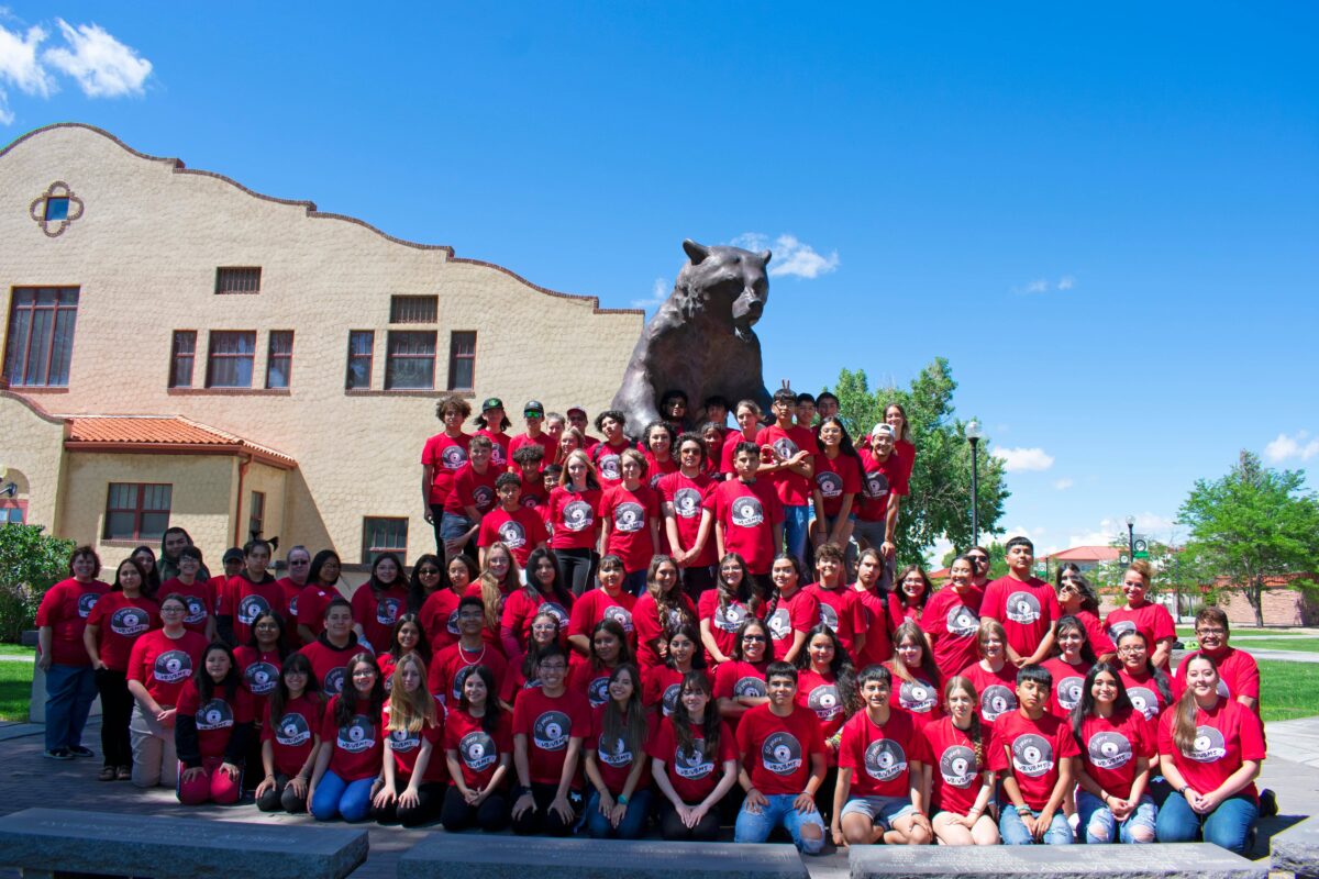 AdamsState's Upward Bound Group for Summer 2022 poses around the stature of Old Mose grizzly bear on the Adams State campus.
