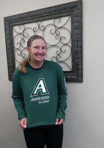 Stephanie Framel smiles and show off her Homecoming 2023 t-shirt, 