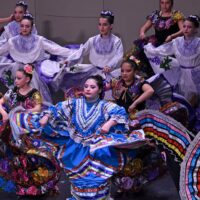 Adams State University Semillas de la Tierra Dance Group performing on Richardson Hall Auditorium stage
