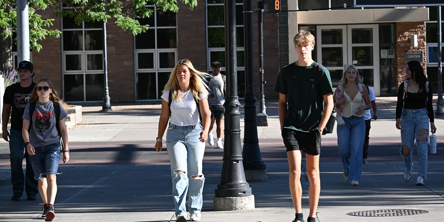 Adams State University students crossing first street in Alamosa