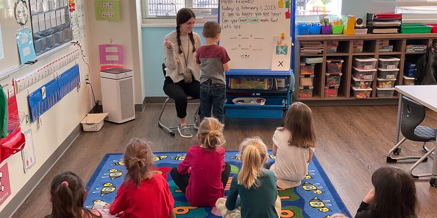 teacher and students in elementary school classroom