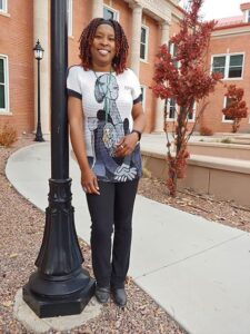 Adams State University Alumna Annaliesa Connor-Meissner in front of Richardson Hall