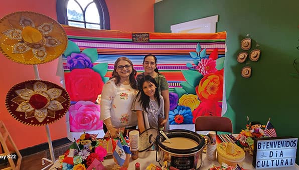 Elisamaria Heredia (left) serves a Mexican beverage called champurrado. She is assisted by Juana Hernandez Alcantar and her daughter, Katherine Arce Hernandez