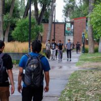 Adams State University students walking across campus
