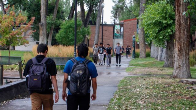 Adams State University students walking across campus