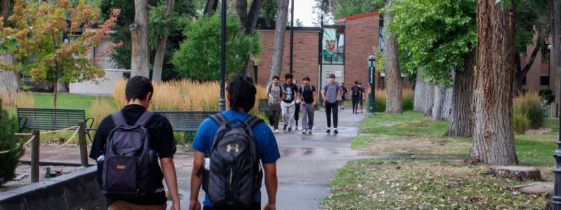 Adams State University students walking across campus