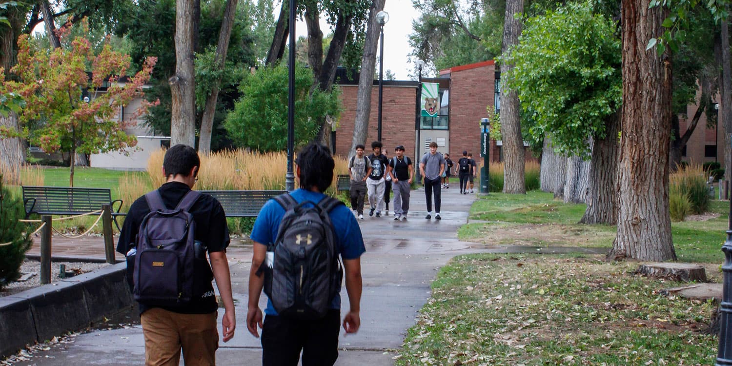 Adams State University students walking across campus