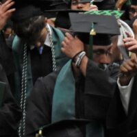 Adams State graduates switch their tassels at commencement.