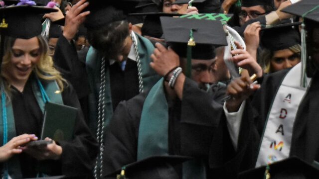 Adams State graduates switch their tassels at commencement.