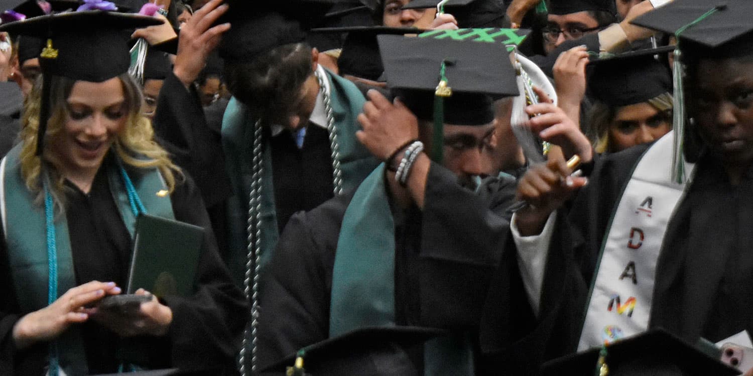 Adams State graduates switch their tassels at commencement.