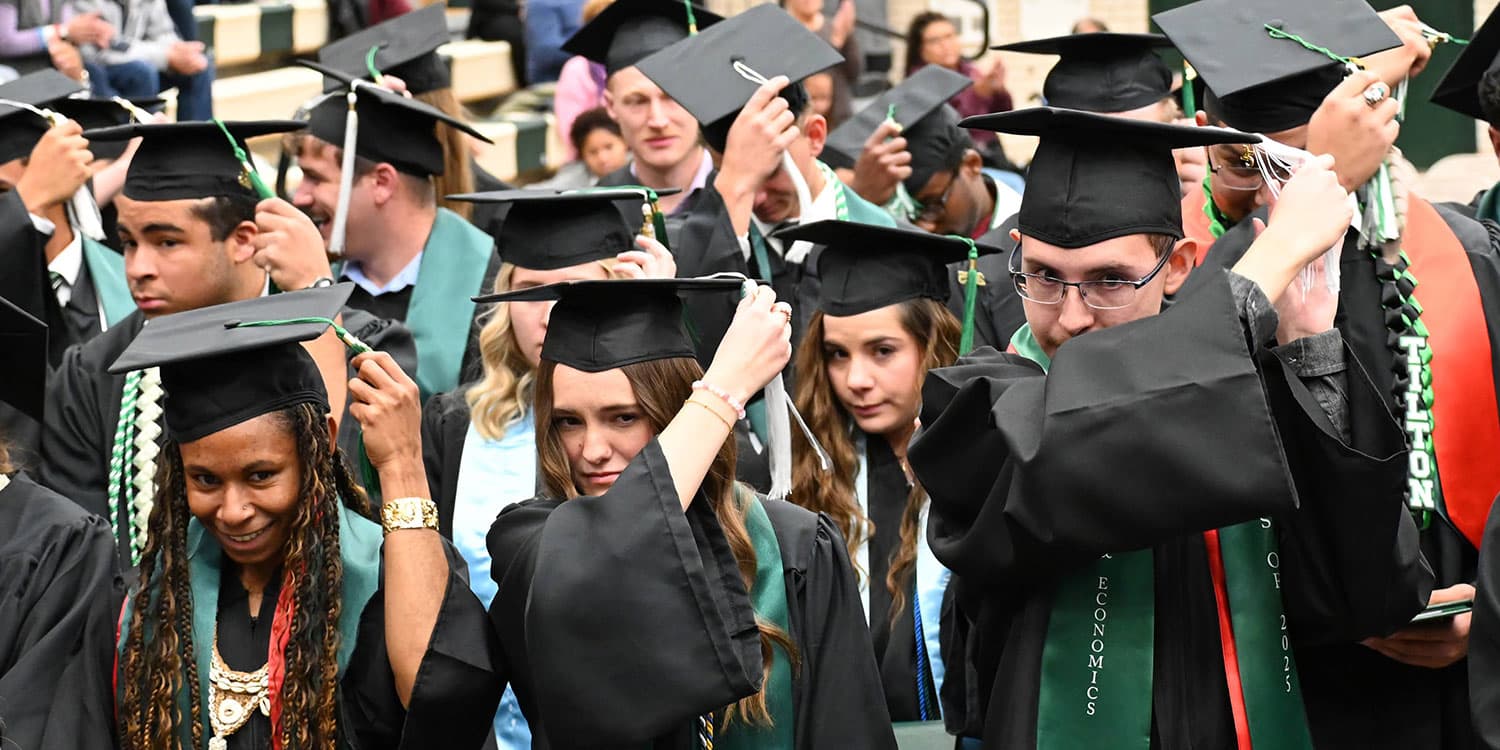 Adams State University 2025 Fall Commencement Graduates switch tassels from right to left