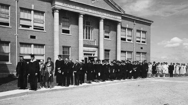 Adams State University 1930 Commencement graduates lined up outside of Richardson Hall