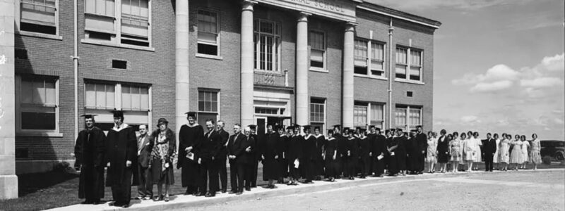 Adams State University 1930 Commencement graduates lined up outside of Richardson Hall