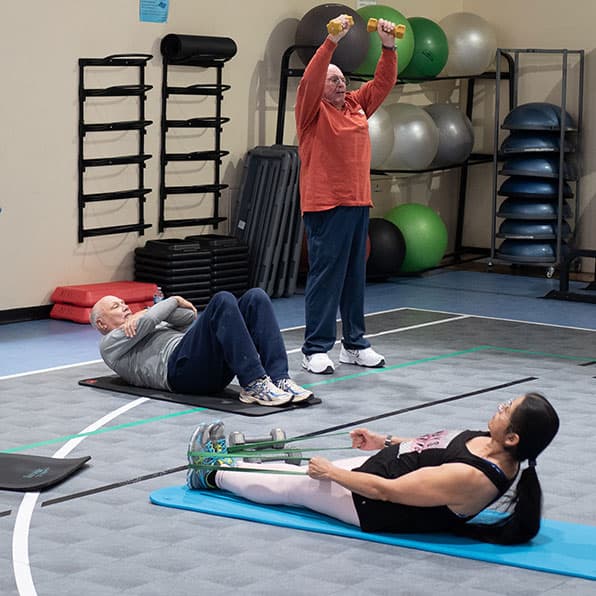 participants in the spring 2024 Larry Holder Exercise and Cancer Survivorship program working through a resistance training circuit