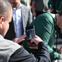 Adams State University Computing Services Building Beam Topping Ceremony, Dr. Savala DeVoge signing beam, Dr. Florencio Urias Aranda taking a video