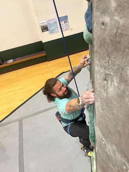 Adams State University Climbing Wall student climbing