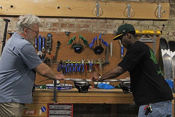 Wil Rickards assists with tuning skis in the Rex Activity Center.