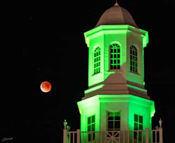 Adams State University Richardson Hall with red moon at night
