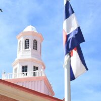 Adams State University Richardson Hall cupola with Colorado flag and soaring bird