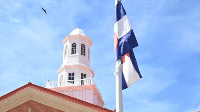 Adams State University Richardson Hall cupola with Colorado flag and soaring bird