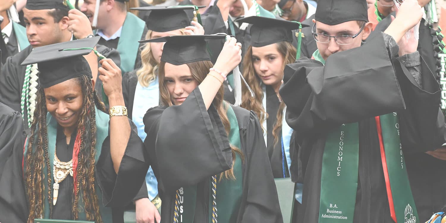 Adams State University 2025 Fall Commencement Ceremony graduates switching tassels