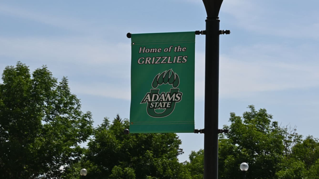 Adams State University Banner on Flag Pole Home of the Grizzlies