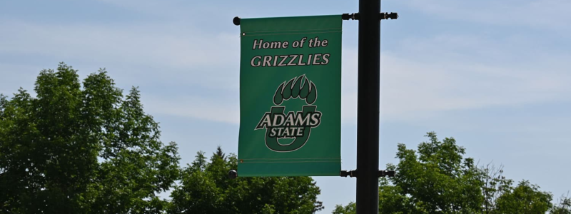 Adams State University Banner on Flag Pole Home of the Grizzlies