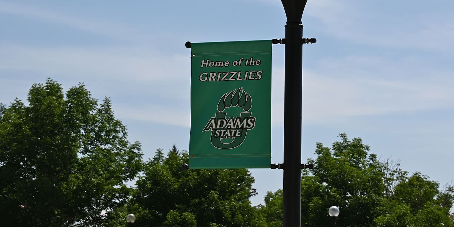 Adams State University Banner on Flag Pole Home of the Grizzlies