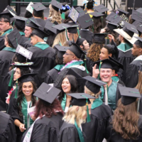 Adams State University Spring 2026 Undergraduate Commencement Ceremony Graduates in rows looking up