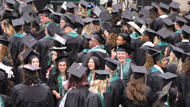 Adams State University Spring 2026 Undergraduate Commencement Ceremony Graduates in rows looking up