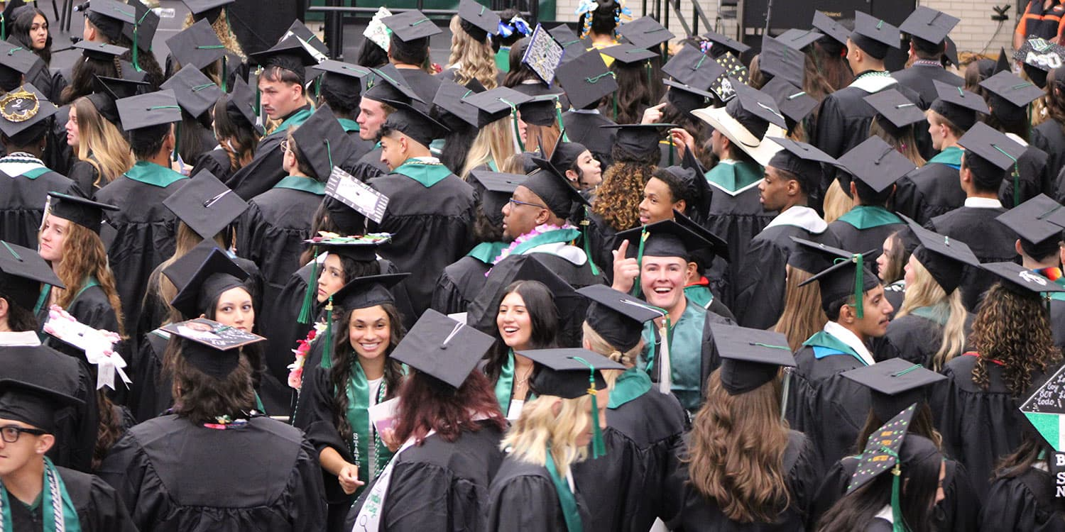 Adams State University Spring 2026 Undergraduate Commencement Ceremony Graduates in rows looking up