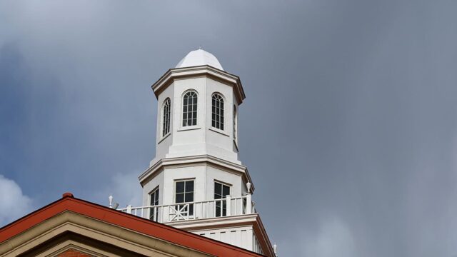 Adams State University Richardson Hall cupola with stormy clouds